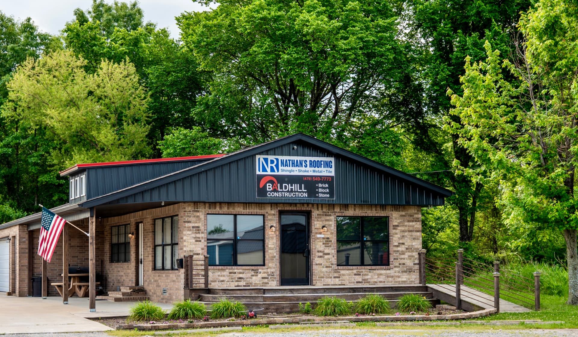 The Nathan's Roofing shop and work trucks in Siloam Springs, Arkansas